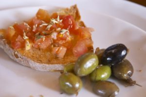 Toast with fresh tomatoes and herbs with olives
