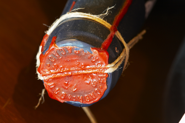 An old bottle with a wax seal and tied cork