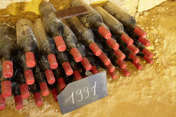 Old wine bottles resting in the cellar