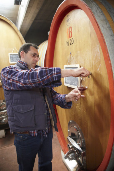 The winemaker taking a tank sample of Etna wine