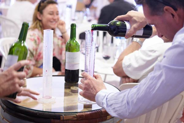 Carefully measuring wine in a measuring glass