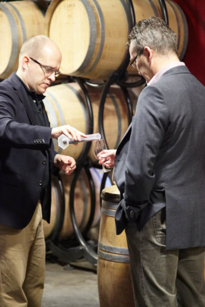 Carefully measuring wine in a measuring glass