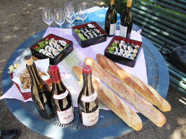 Bottles of Sancerre wine, bread and food in the garden, Loire