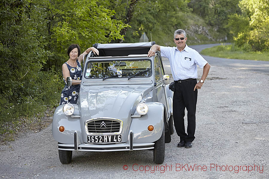 Two people by the car, a Citroen 2CV