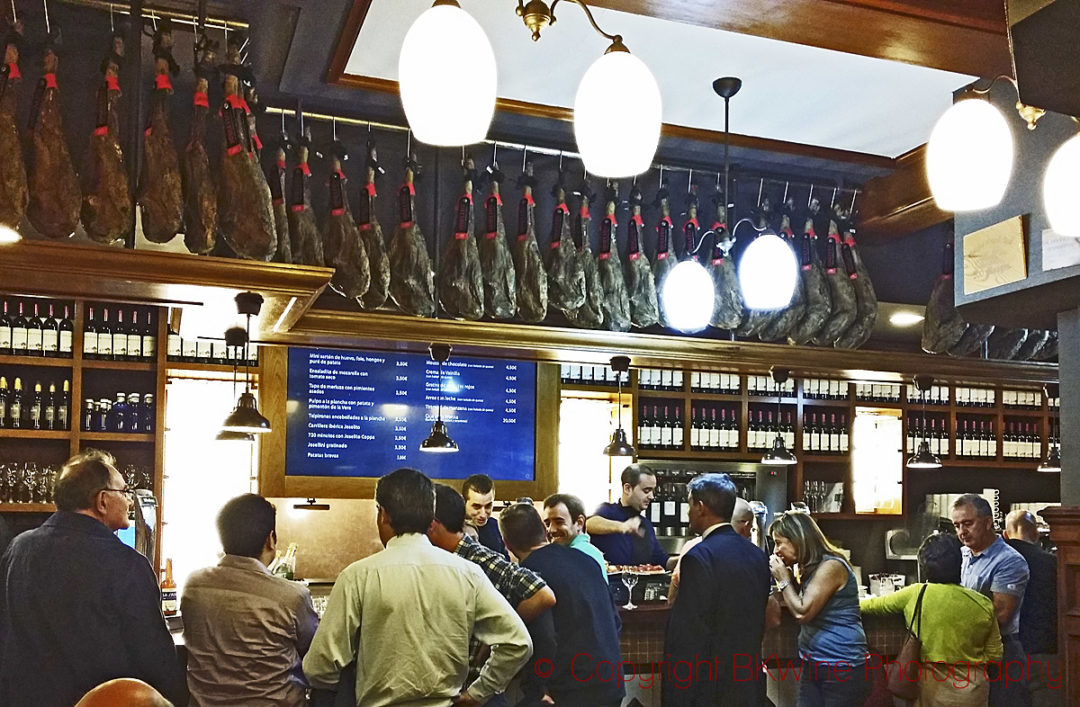 A bar in Bilbao with cured hams hanging from the ceiling