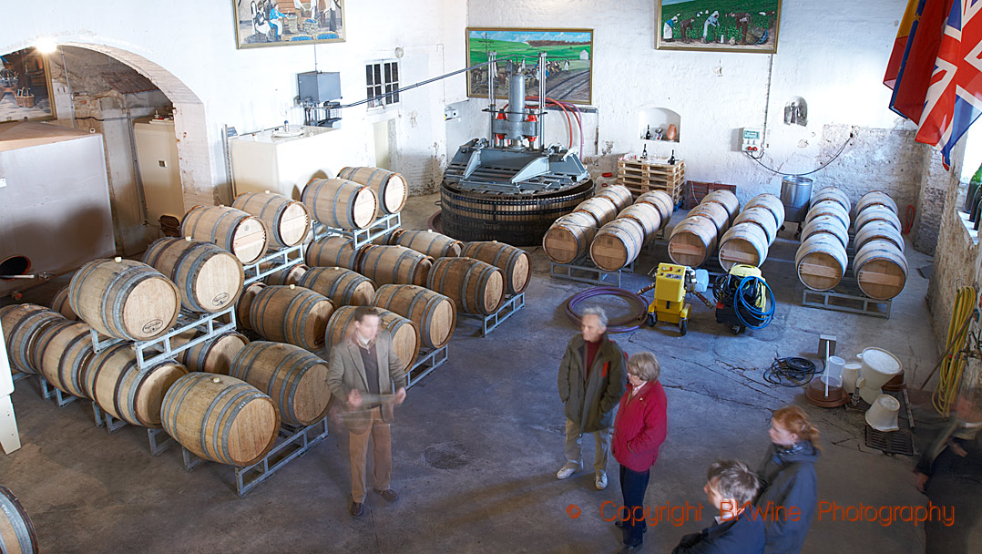 Oak barrels and a press in a cellar in Champagne