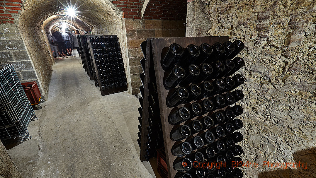 Bottles in pupitres in an underground cellar in Champagne