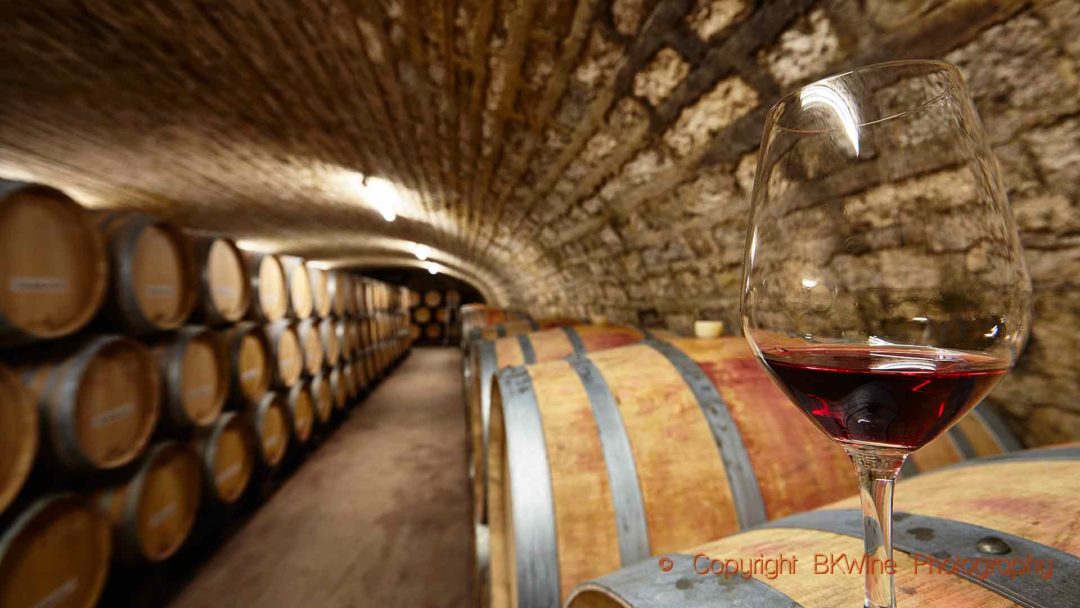 Wine ageing in barrels in a cellar in Burgundy