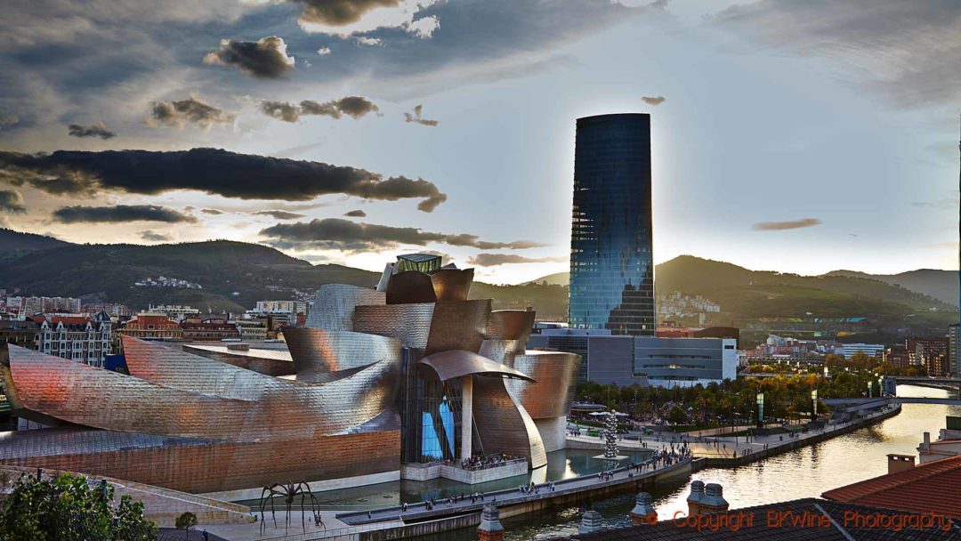 The Guggenheim museum in the evening sunshine and Bilbao's tallest building