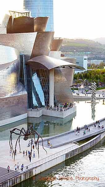 The Guggenheim museum in Bilbao on the in the Nerviòn river flowing out in the Bay of Biscay