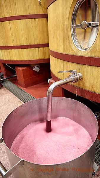 Pumping over a wooden vats in a wine cellar in Rioja