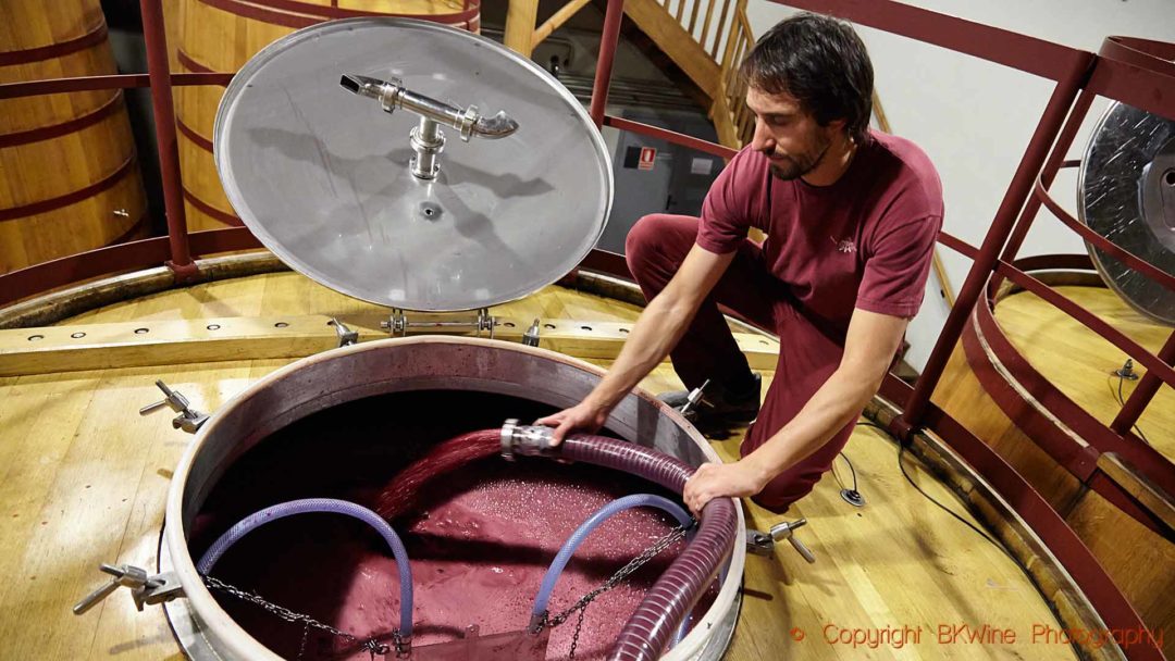 Pumping over a wooden vats in a wine cellar in Rioja