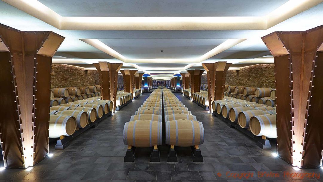 Rows of wine barrels in an modern wine cellar in Rioja