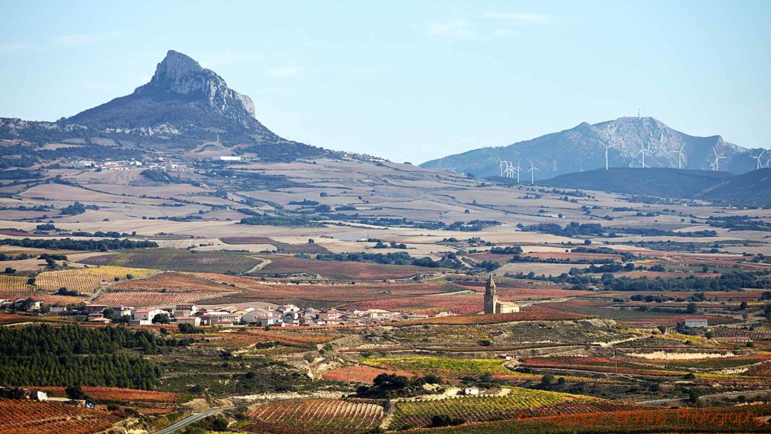 The dramatic Cantabrian Mountains, a village and vineyards in Rioja