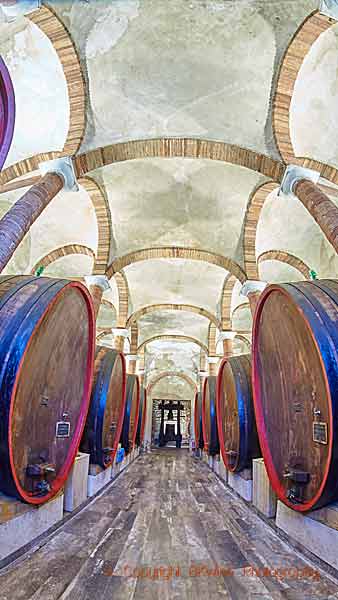 Big oak barrels, botti, in a wine cellar in Tuscany