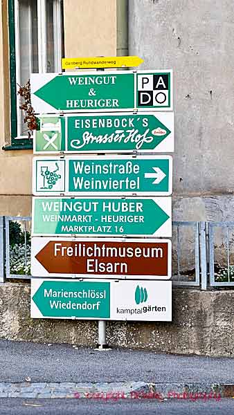 Street signs to wineries and restaurants in a wine village in Austria