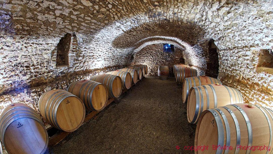 A wine cellar with oak barrels at a vineyard in the Loire Valley