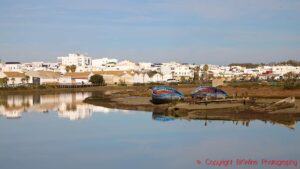 A village with whitewashed houses along the river, and boats, near Jerez de la Frontera, Andalusia