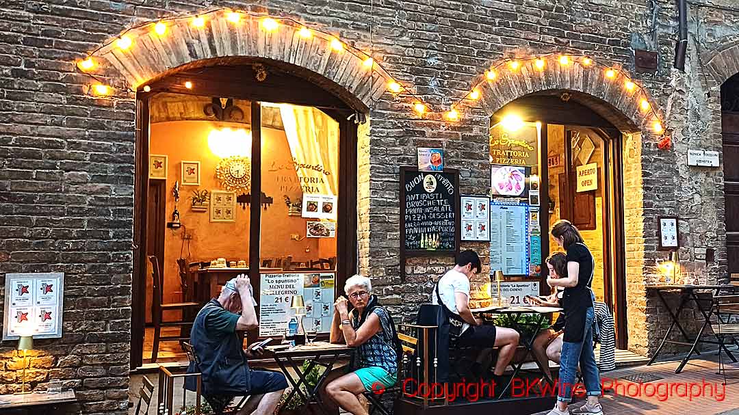 Diners enjoying a meal at a trattoria pizzeria in Italy