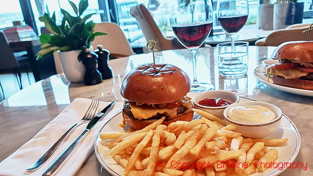A wagyu burger and fries at The Living Room at Park Hyatt in Auckland